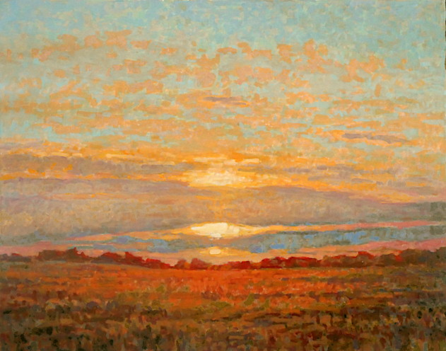 Spectacular orange light filled sky glowing through the grass.